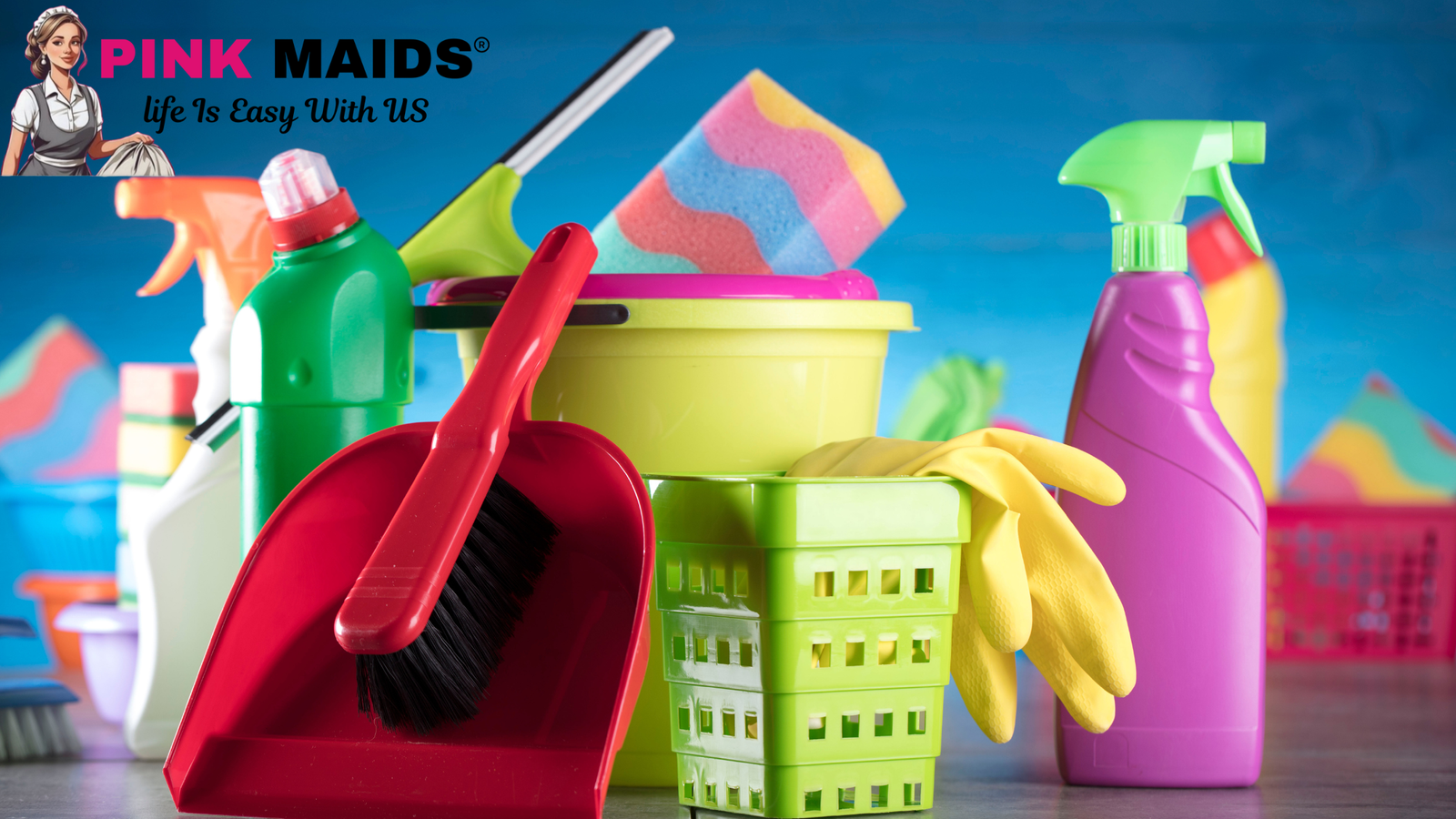 Colorful cleaning supplies including spray bottles, gloves, sponges, and a bucket arranged on a table with The Pink Maids Cleaning Service logo — representing a complete cleaning supplies checklist.