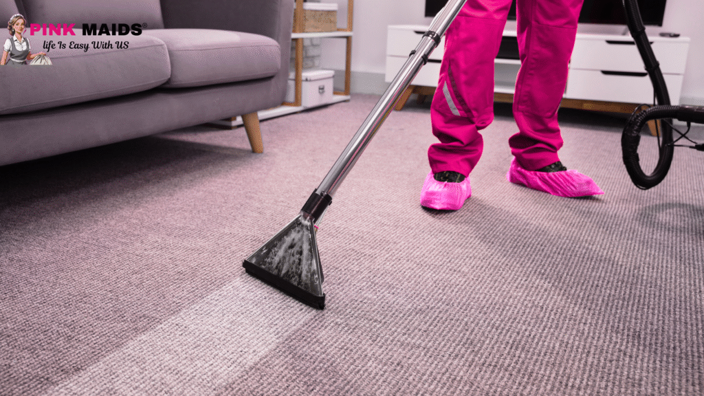A team of professional cleaners in distinctive pink uniforms performing a deep clean of a Vancouver home, showcasing the thorough benefits of hiring a professional cleaning company.